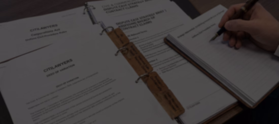 A professional top-down, close-up landscape header image featuring a subtle dark color overlay for website hero text compatibility. The desk workspace displays organized legal files and binders from Citilawyers, including a "Dispute Case Strategy Brief | Assessing Breach of Contract Claims" document with specialized leather index tabs labeled "Relevant Terms," "Breach of Supply / Business Sale / Warranty Claims," "Restraint / Confidentiality," and "Debt Recovery / Non-Payment." On the right, a commercial litigator's hand in a professional suit holds a classic fountain pen, drafting notes on a notepad with the heading "Uniform Civil Procedure Rules" next to an open "Deed of Variation" document.